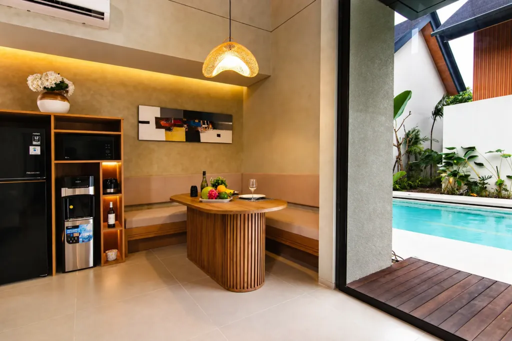 Dining area with table and chairs alongside the open kitchen, Villa Umahan Sanur