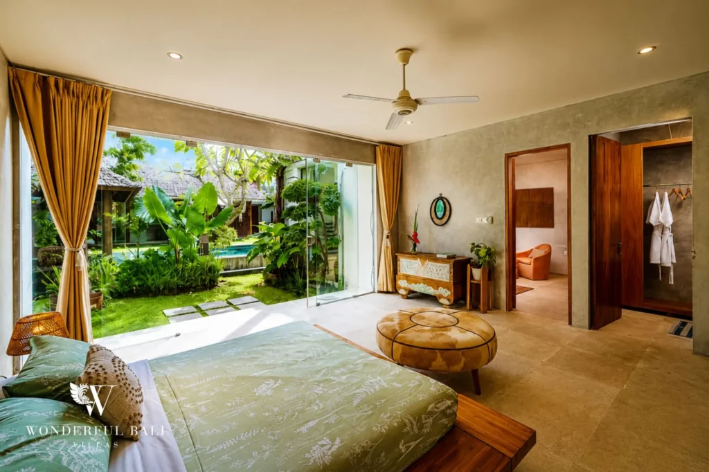 Bedroom with open doorway and garden view, 4-bedroom villa in Petitenget, Seminyak