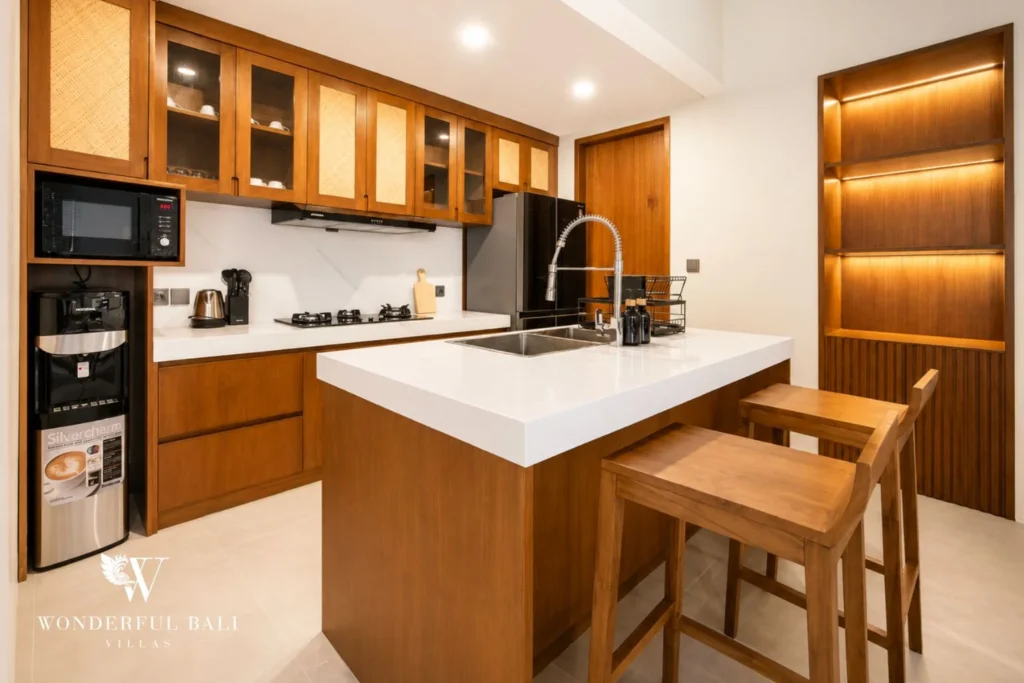 Equipped kitchen with timber cabinetry and bar stools in Tumbak Bayuh, Bali