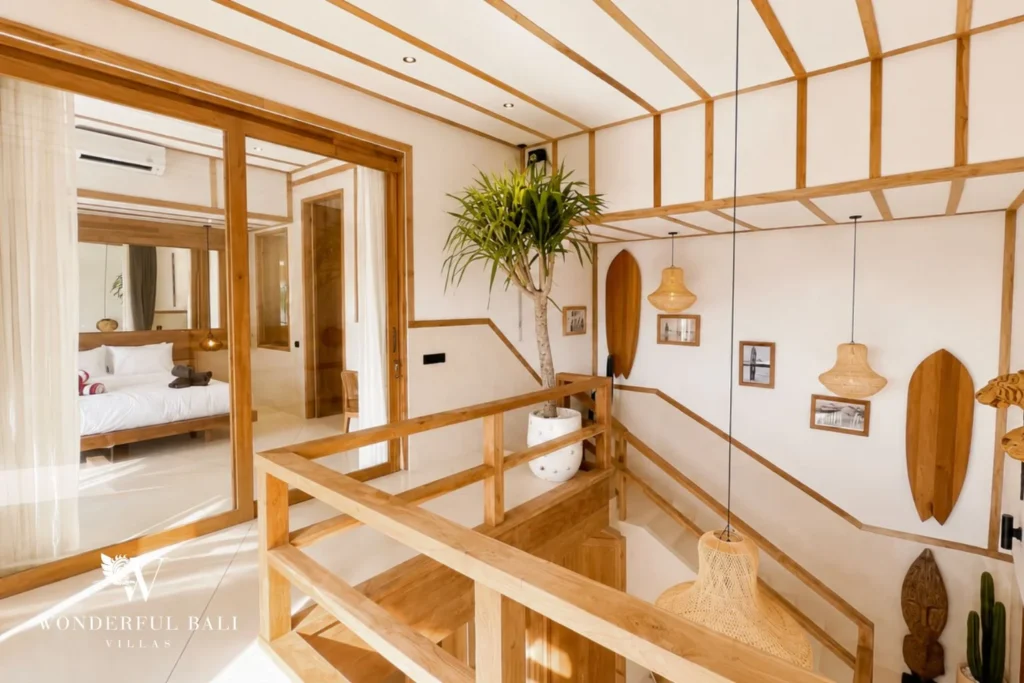 Upstairs landing with timber beams and surfboard wall art in Berawa, Bali