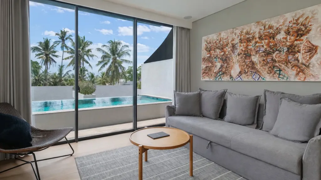 Villa Umahan, Ubud — living room, sofa and full-height windows onto the pool, Villa Umahan