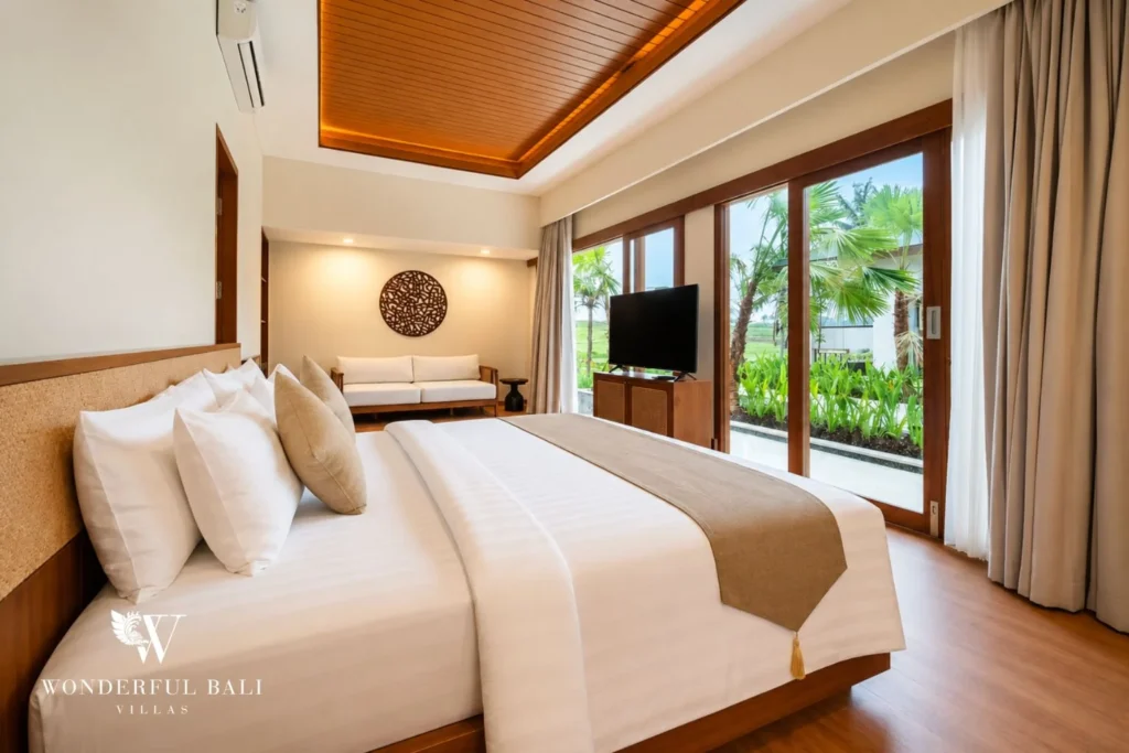 Master bedroom with king bed, sofa and rice field view in Tumbak Bayuh, Bali
