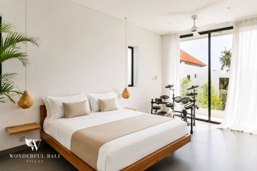 Second bedroom with king bed and balcony access at Luxury 3BR Villa in Pererenan, Bali