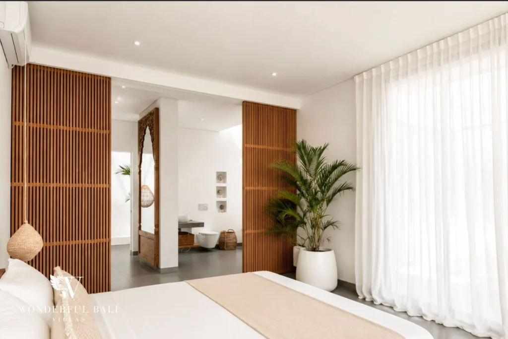 Bedroom with timber slatted screen doors to ensuite at Luxury 3BR Villa in Pererenan, Bali