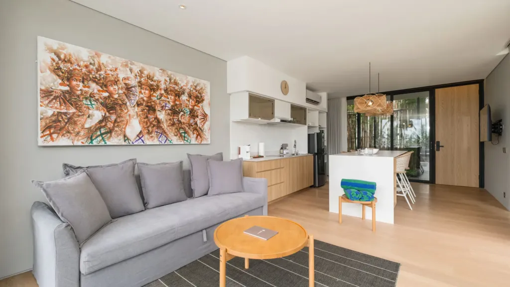 Villa Umahan, Ubud — living room, sofa, large artwork and view to kitchen, Villa Umahan
