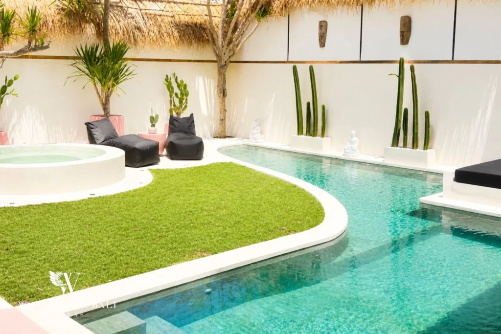 Curved pool with jacuzzi, lawn and cactus wall in Berawa, Bali