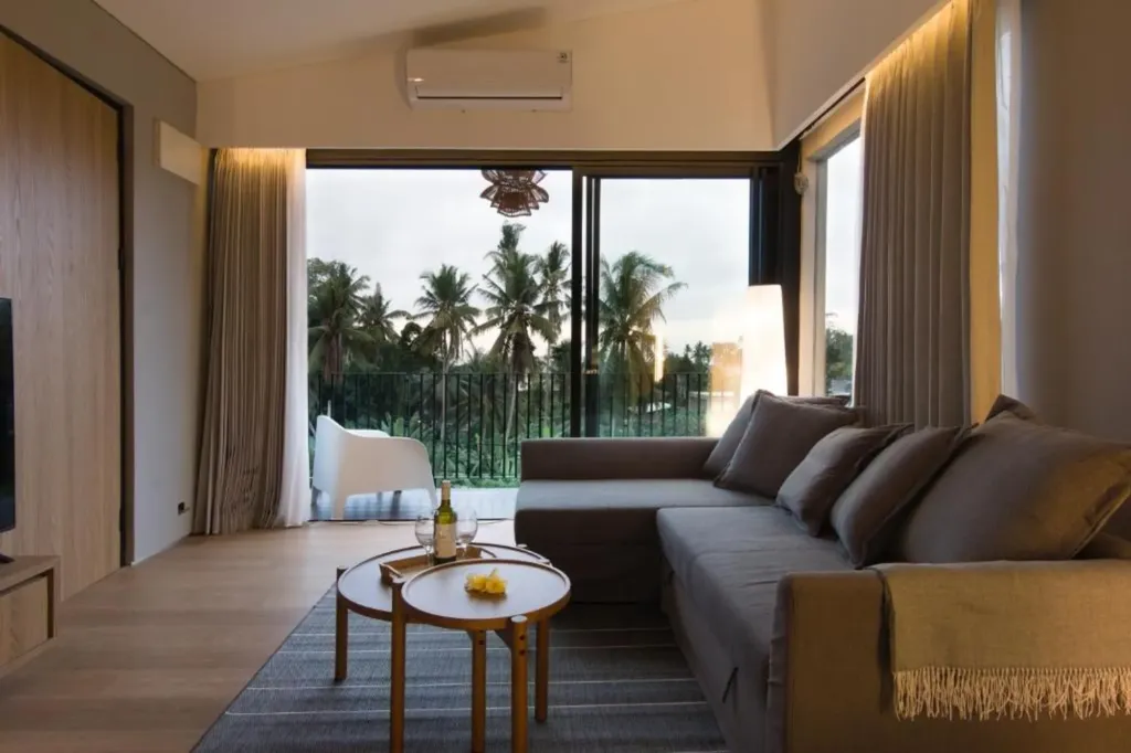 Villa Umahan, Ubud — living room, evening with sofa and palm view through balcony, Villa Umahan