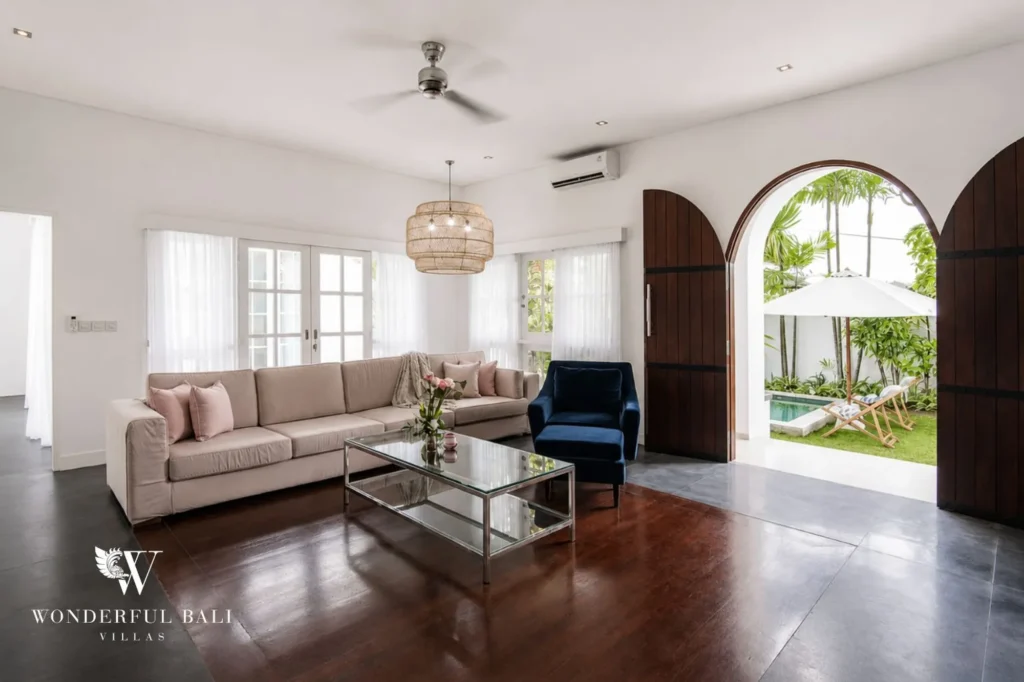 Living room with arched windows letting in natural light, 3-bedroom colonial villa in Umalas