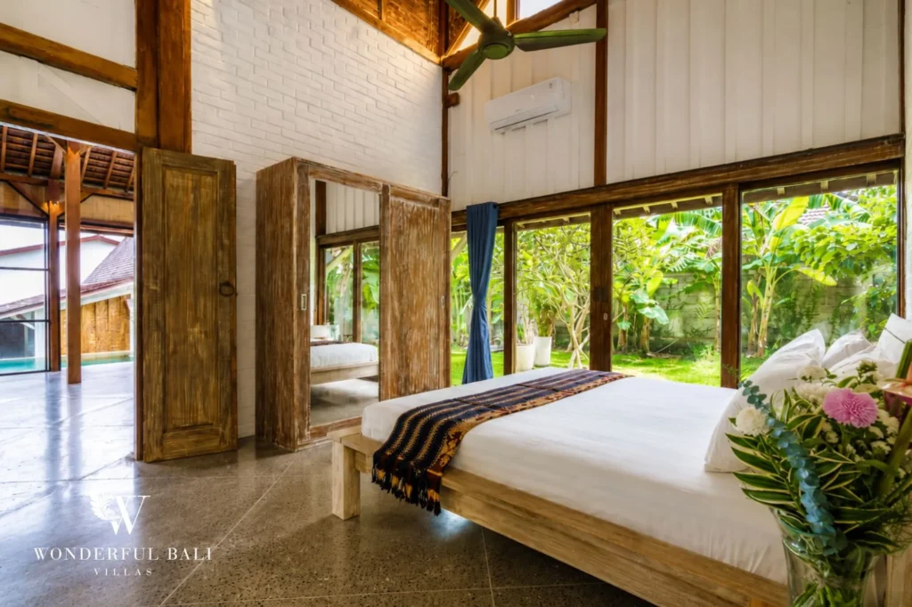 Bedroom with high timber ceiling and coconut-shell panels, dual-villa compound in Pererenan