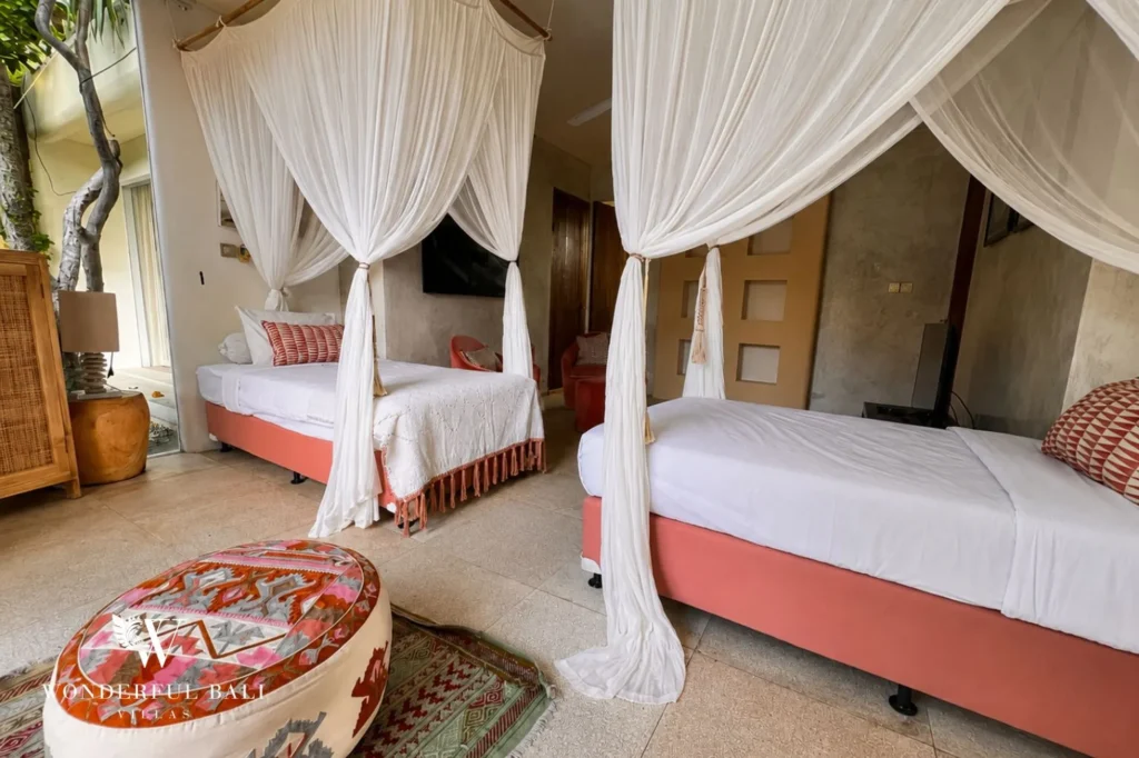 Bedroom with rugs and traditional bed frame, 4-bedroom villa in Petitenget, Seminyak