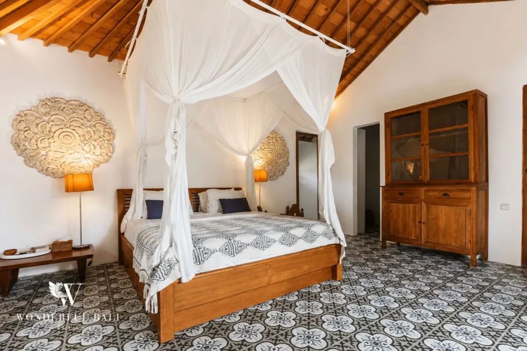 Bedroom with traditional tiled floor and four-poster bed, 4-bedroom joglo villa in Umalas
