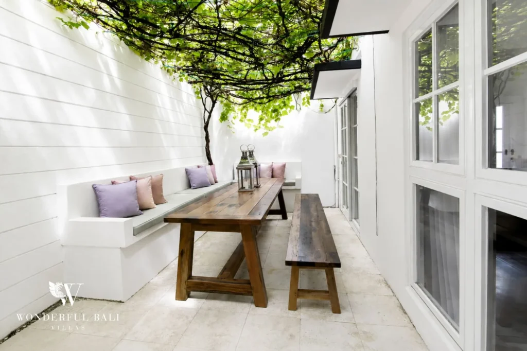 Outdoor dining table set in the manicured garden, 3-bedroom colonial villa in Umalas