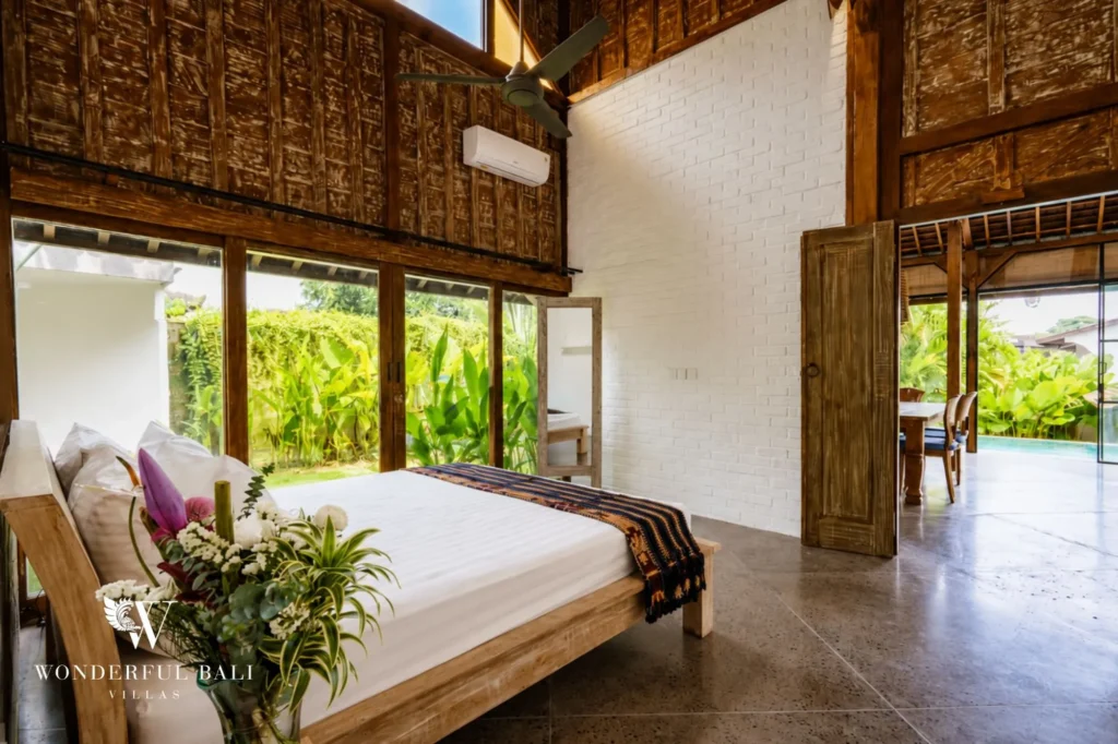 Bedroom with air-conditioning opening to garden views, 4-bedroom dual-villa compound in Pererenan