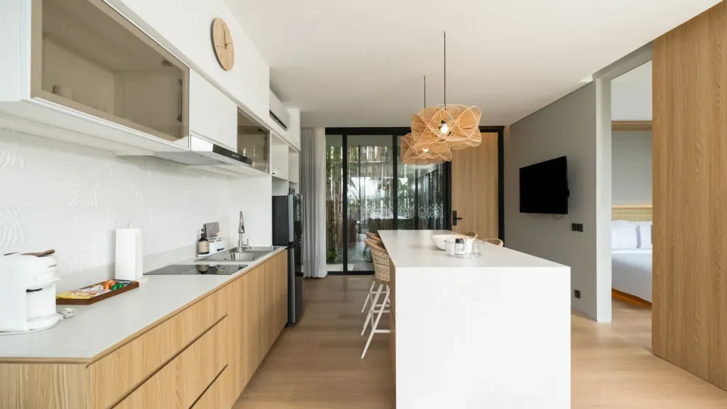 Villa Umahan, Ubud — kitchen, white cabinetry and view through to a bedroom, Villa Umahan