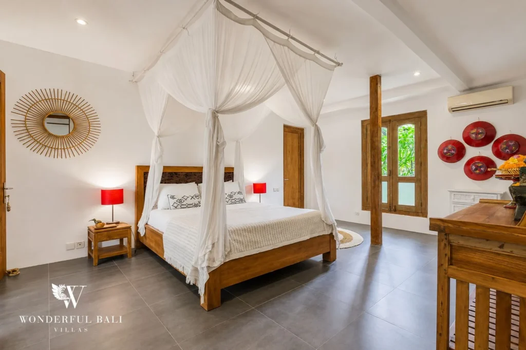 Bedroom nightstand detail and traditional carved bed, 4-bedroom joglo villa in Umalas