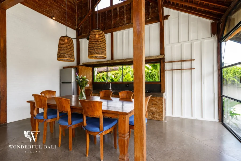 Dining area with timber table and natural materials, dual-villa compound in Pererenan