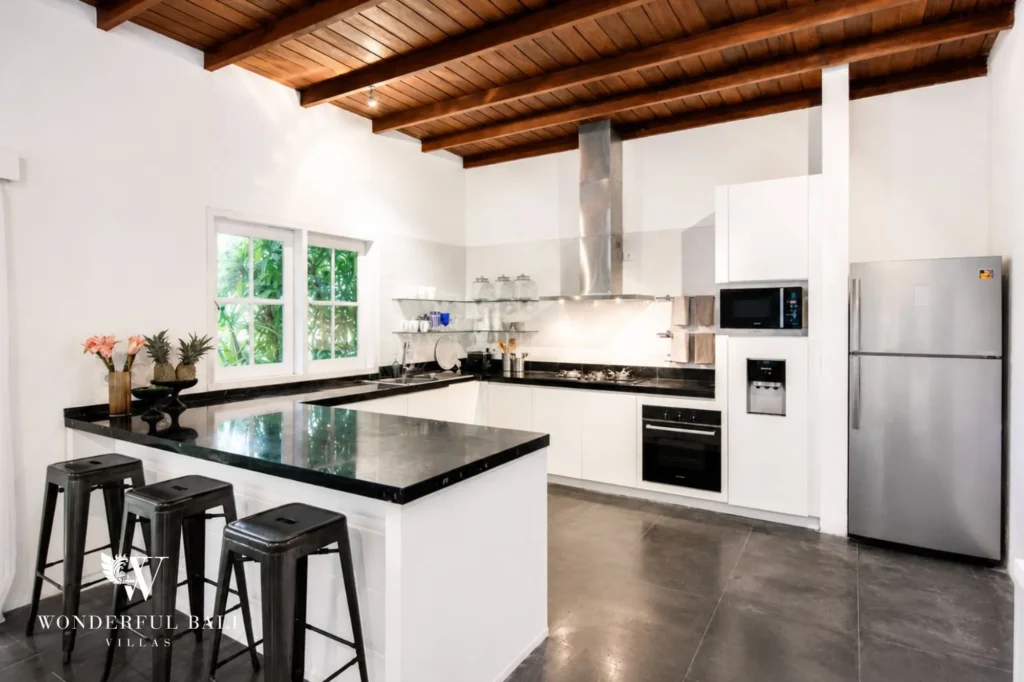 Open-plan kitchen with island and modern appliances, 3-bedroom colonial villa in Umalas