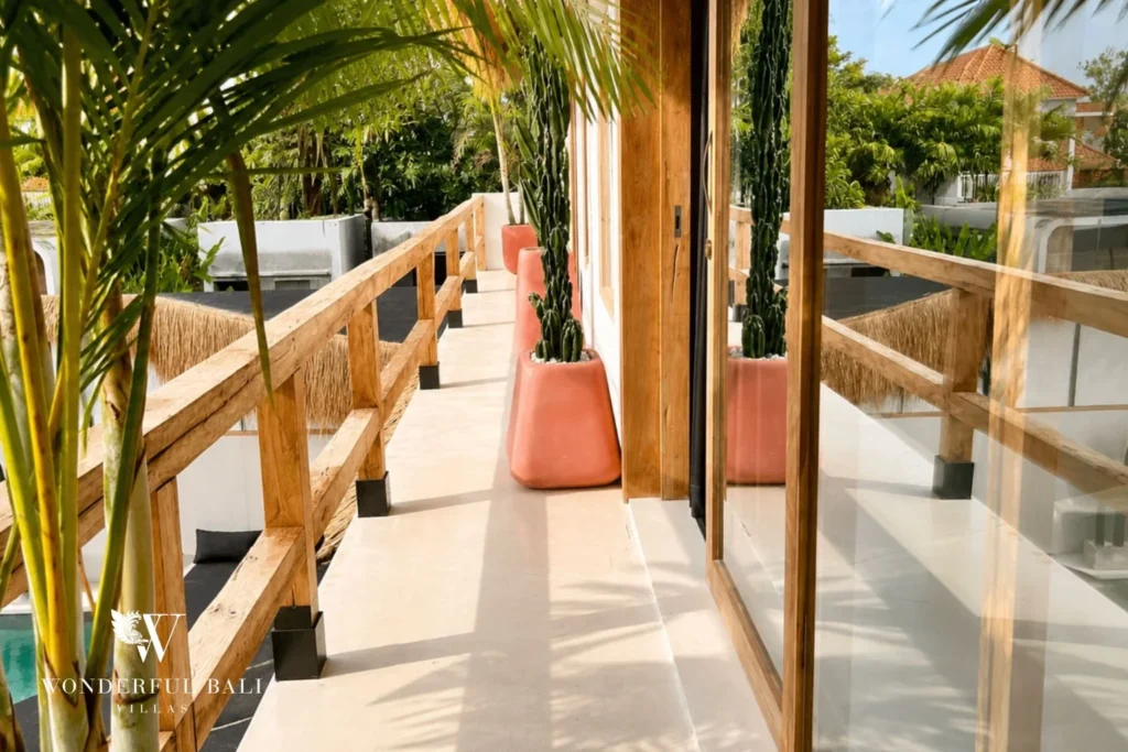Upper-floor walkway with coral planters and palm view in Berawa, Bali