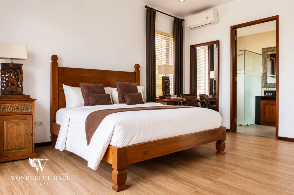 Bedroom with wooden bed frame and traditional finishes, 4-bedroom villa in Berawa, Canggu