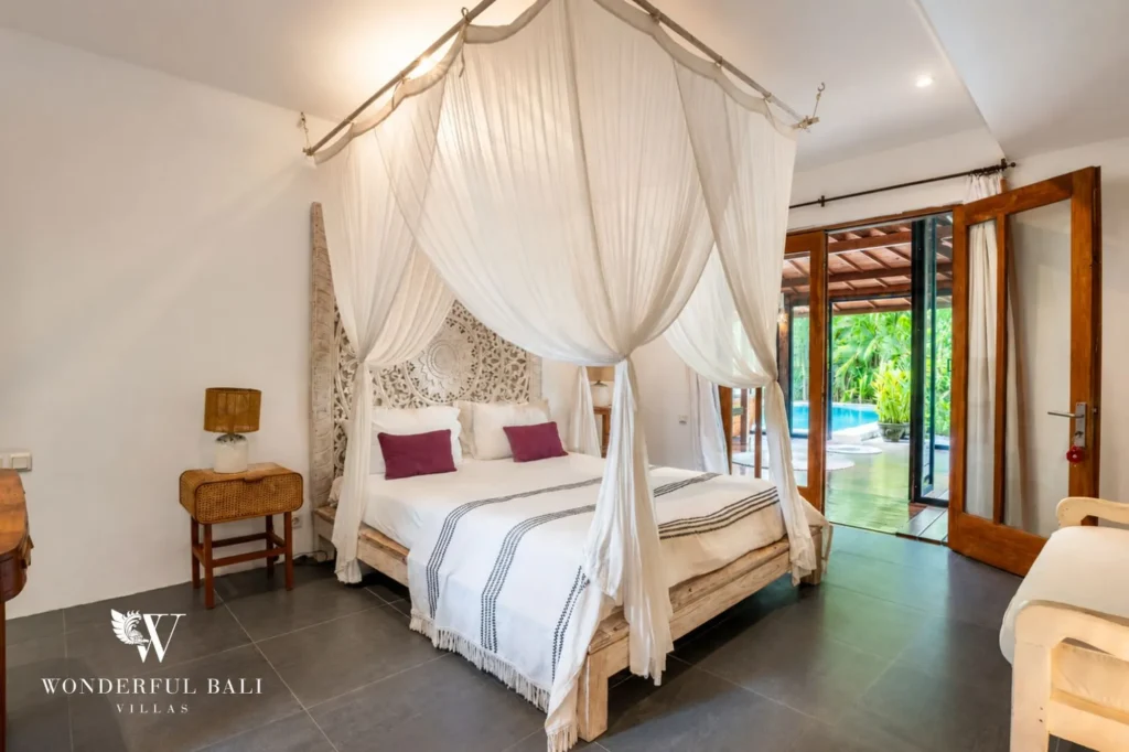 Master bedroom with carved four-poster bed, 4-bedroom joglo villa in Umalas