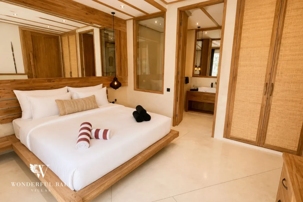 Third bedroom with timber-clad walls and ensuite glimpse in Berawa, Bali