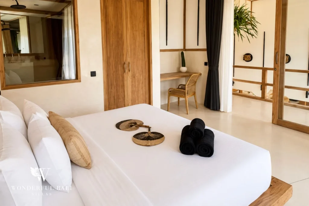 Bedroom with decorative palm fans and rattan wardrobes in Berawa, Bali