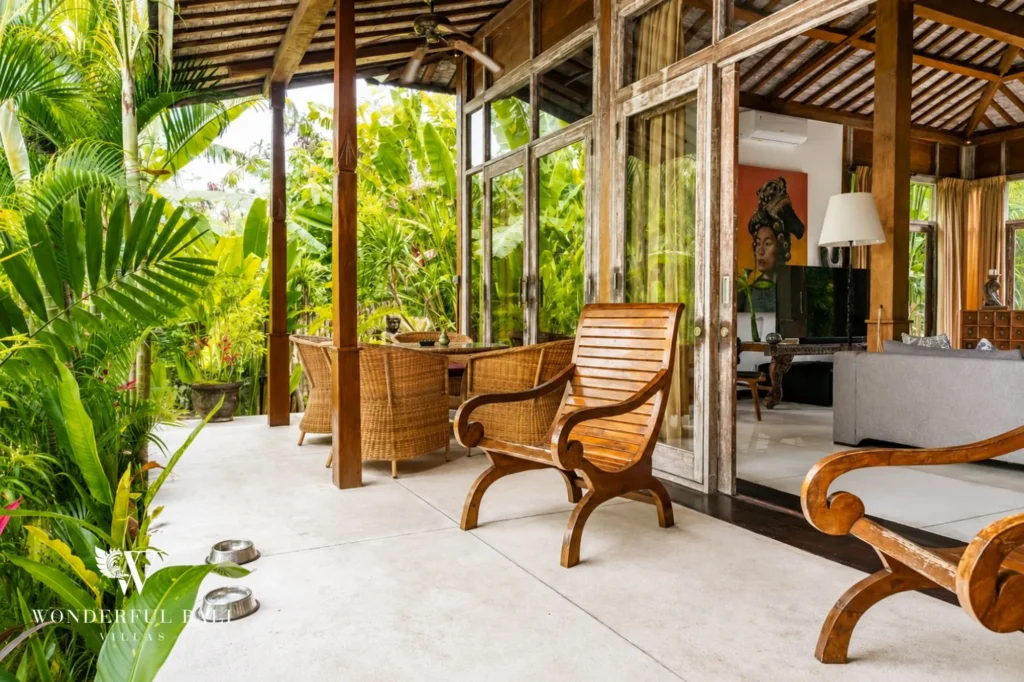 Bedroom doorway opening to a frangipani-framed terrace, 4-bedroom villa in Berawa, Canggu