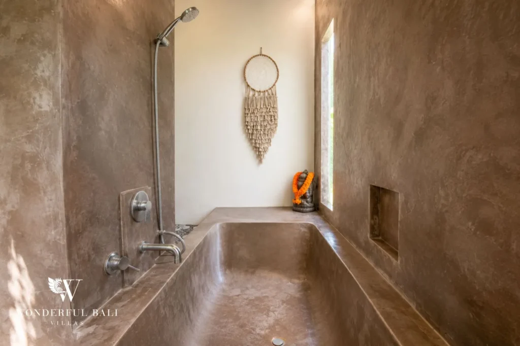 Outdoor shower against stone wall, 4-bedroom joglo villa in Umalas