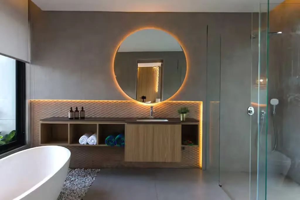 Villa Umahan, Ubud — bathroom, primary bathroom with LED-backlit round mirror, freestanding tub and patterned tile vanity, Villa Umahan