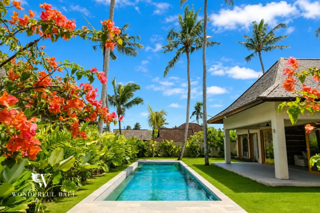 Private pool framed by flowering plants, 4-bedroom villa in Kaba-Kaba, Tabanan