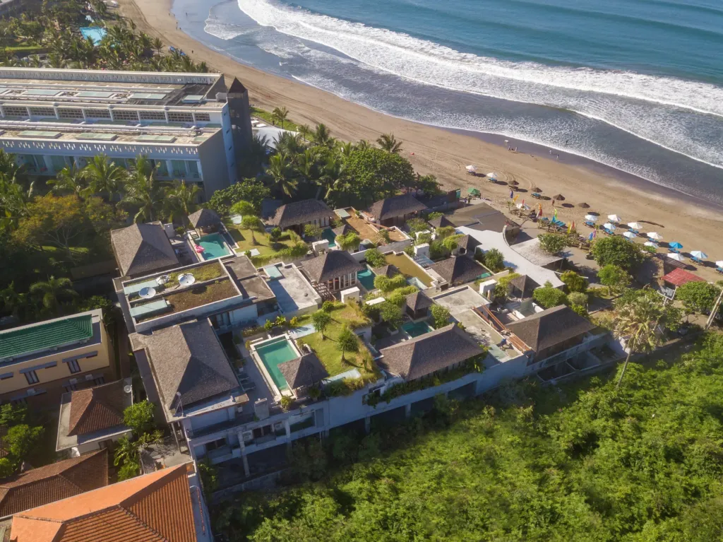 Aerial view of the beachfront villa complex with pools and gardens in Batu Belig, Bali