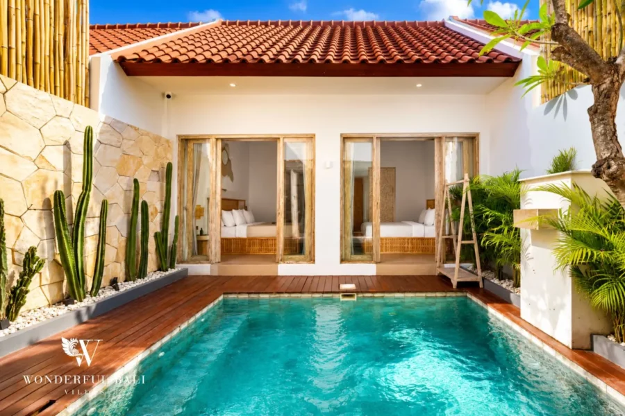 Pool with terracotta-roof villa, cacti and timber deck at villa in Canggu, Bali