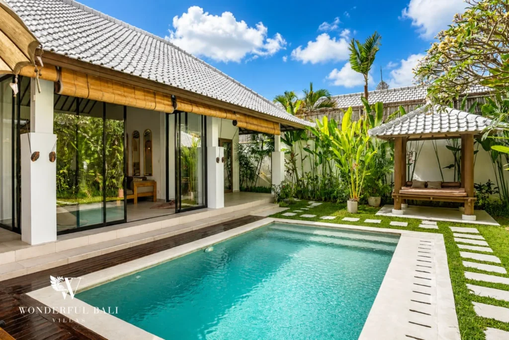 Private pool and sun loungers lit at dusk beside the villa in Umalas, Bali