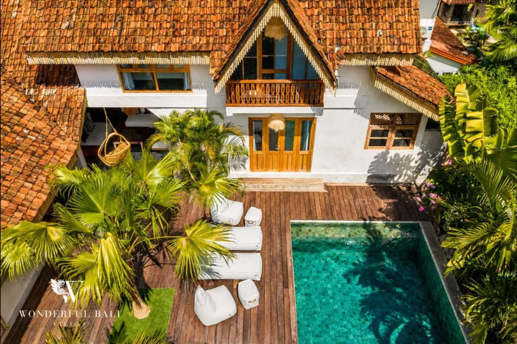 Private pool and sun loungers in a tropical garden at a villa in Canggu, Bali