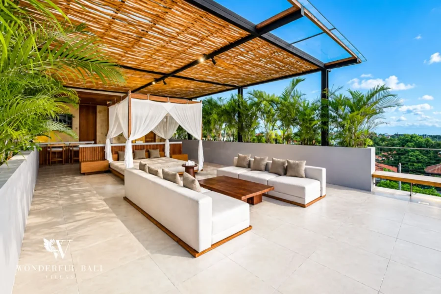 Rooftop terrace lounge with sofa and timber pergola at villa in Umalas, Bali