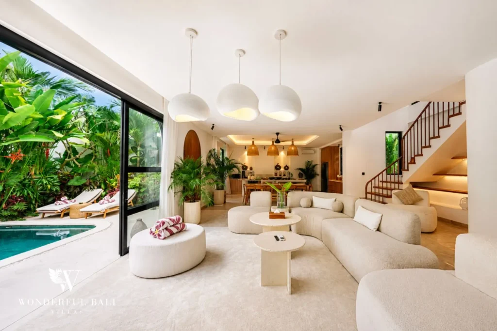 Open living area with glass doors opening to the pool at villa in Umalas, Bali