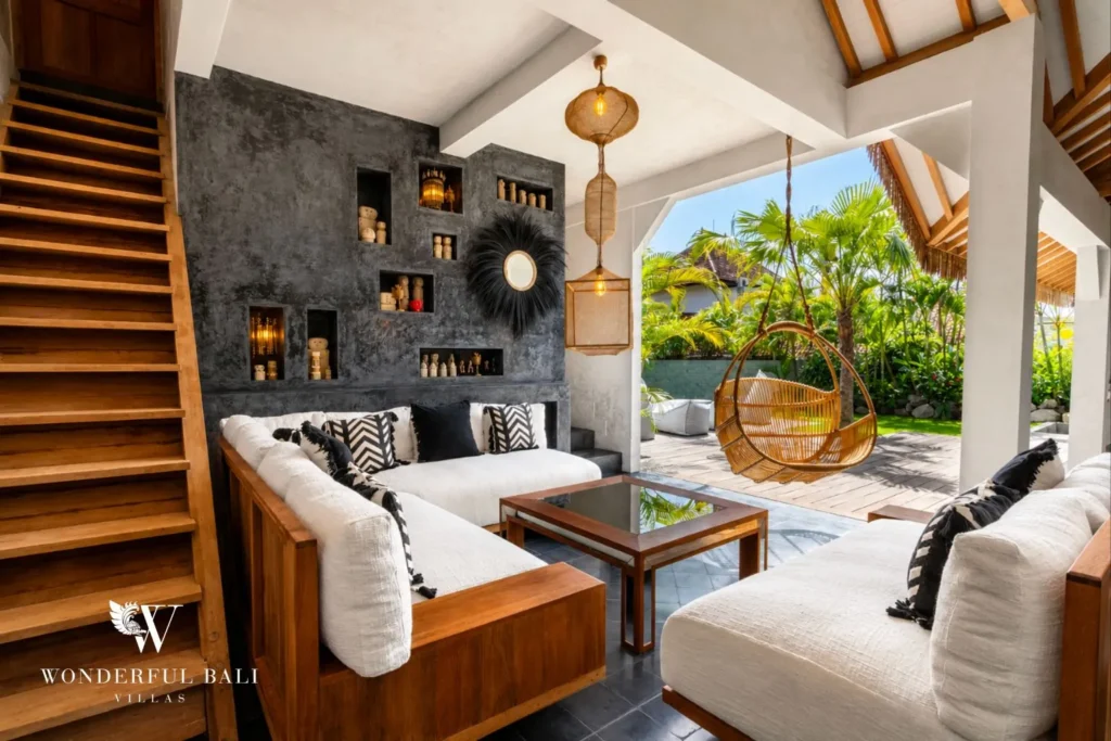 Open living room with stone feature wall and sofa at a villa in Canggu, Bali
