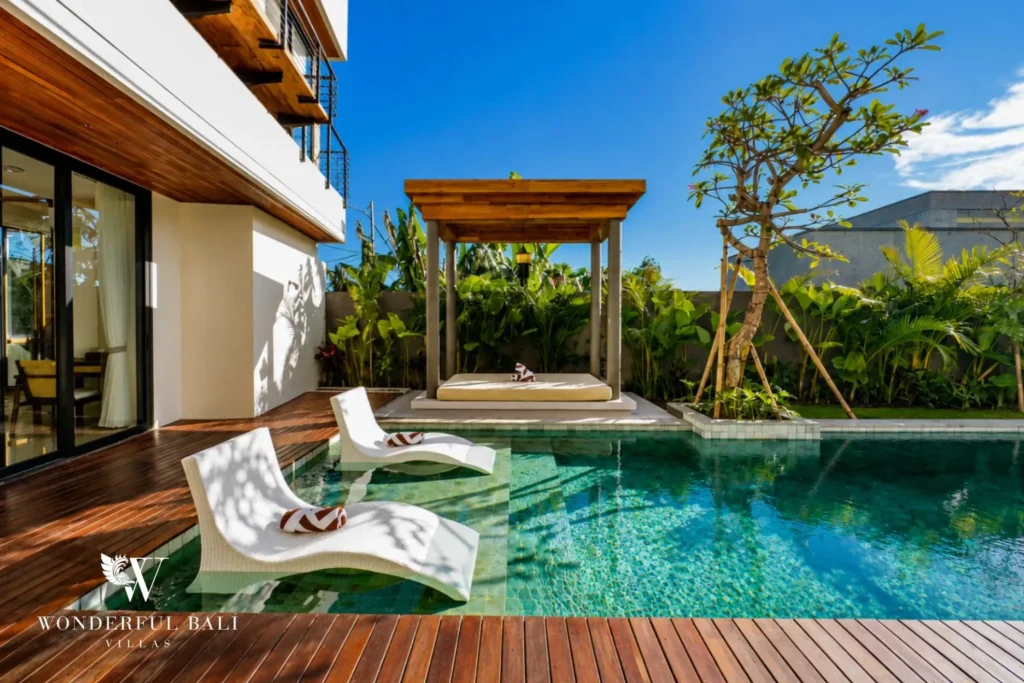 Pool with timber deck and sun loungers at villa in Umalas, Bali