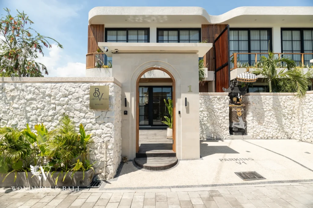 White villa facade with arched entrance at villa in Umalas, Bali