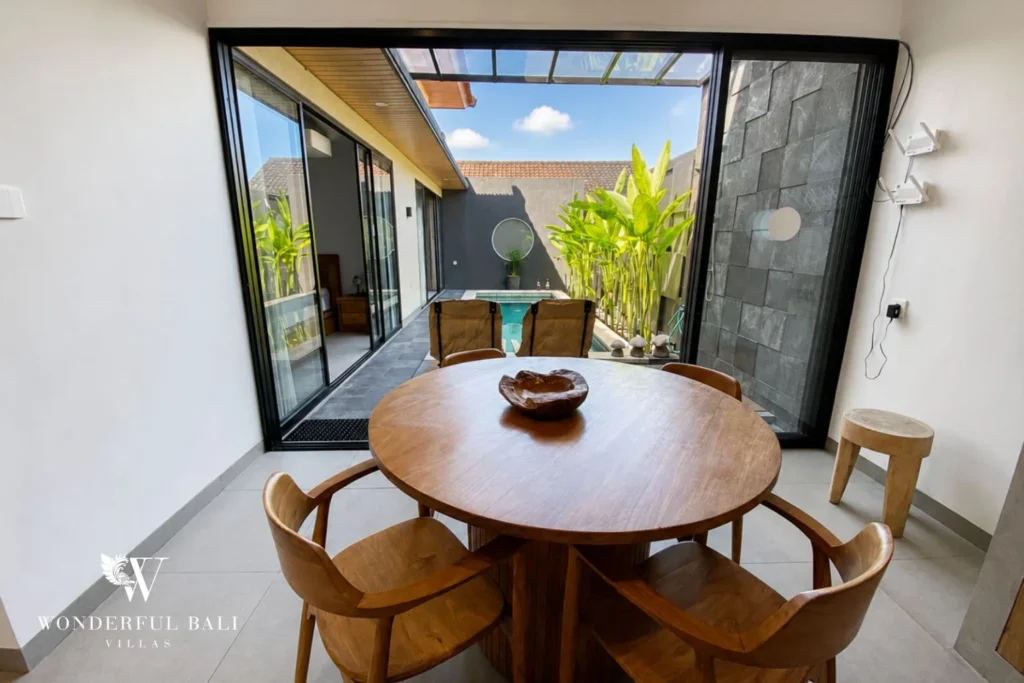 Dining area with pool view at villa in Canggu, Bali