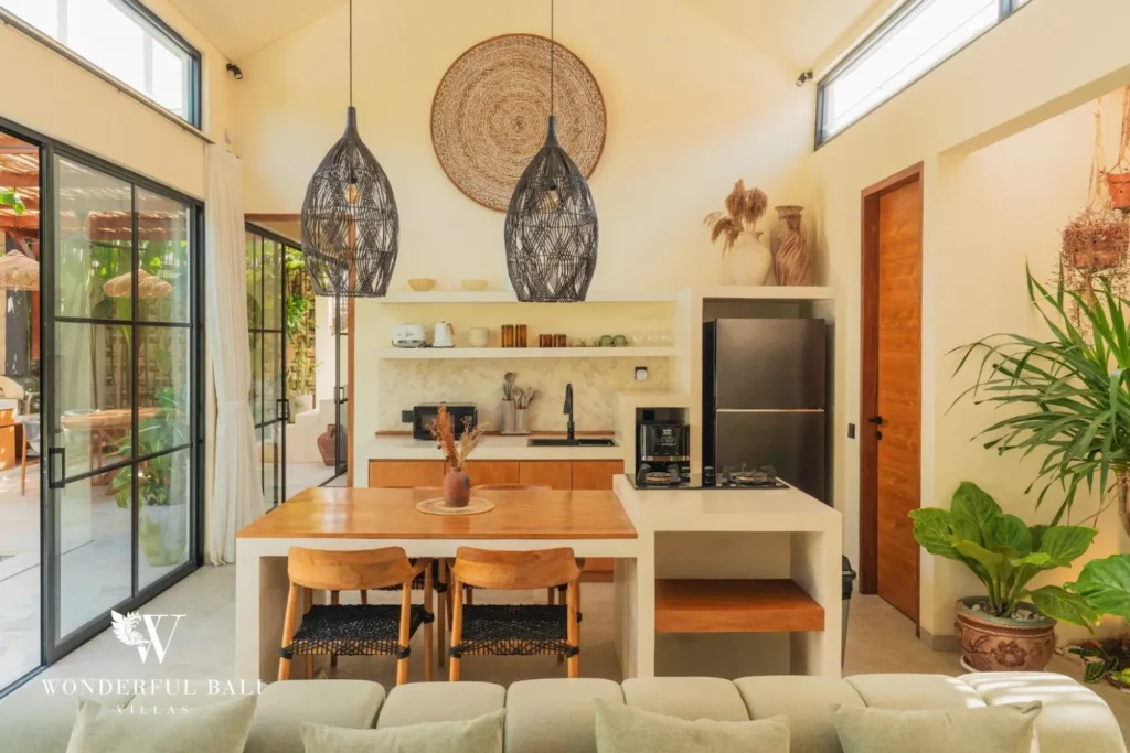 Dining area with rattan pendant and glass doors to garden at villa in Seseh, Bali