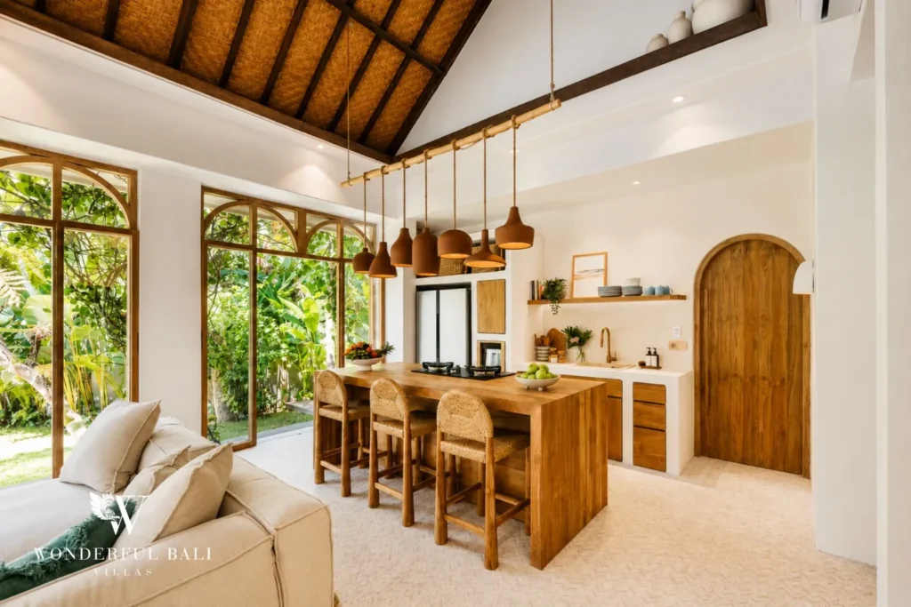 Kitchen island with bar stools and arched detailing at villa in Berawa, Bali