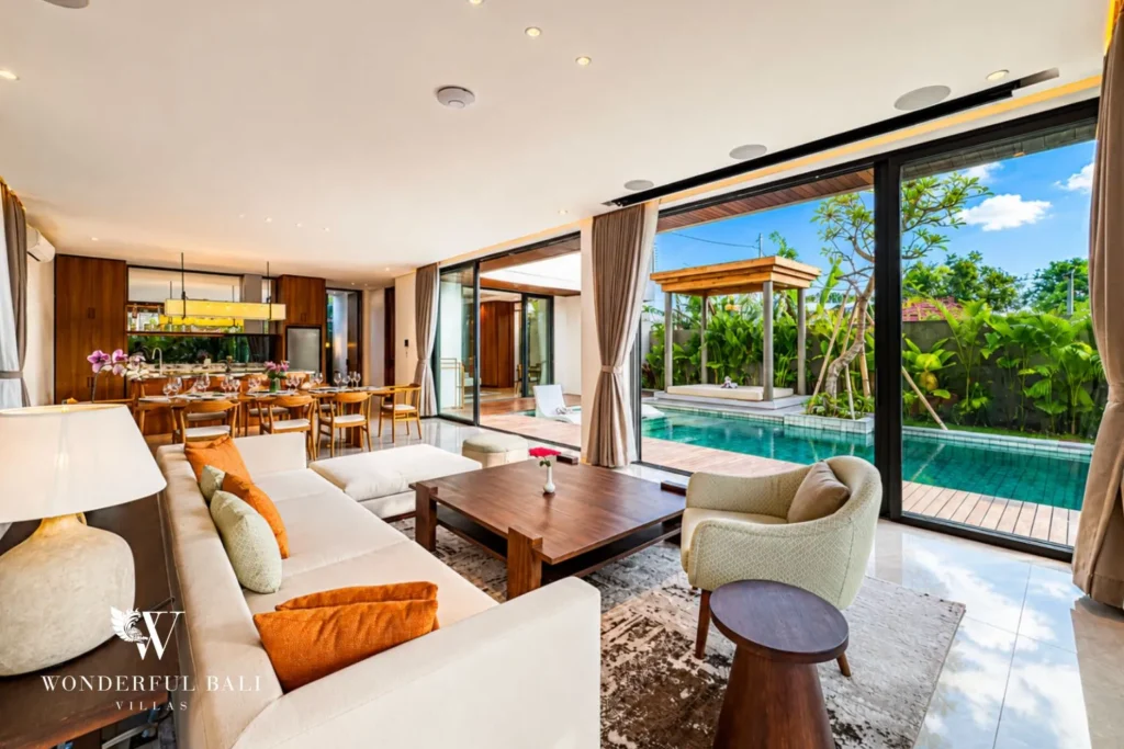 Living area opening to the pool with timber finishes at villa in Umalas, Bali