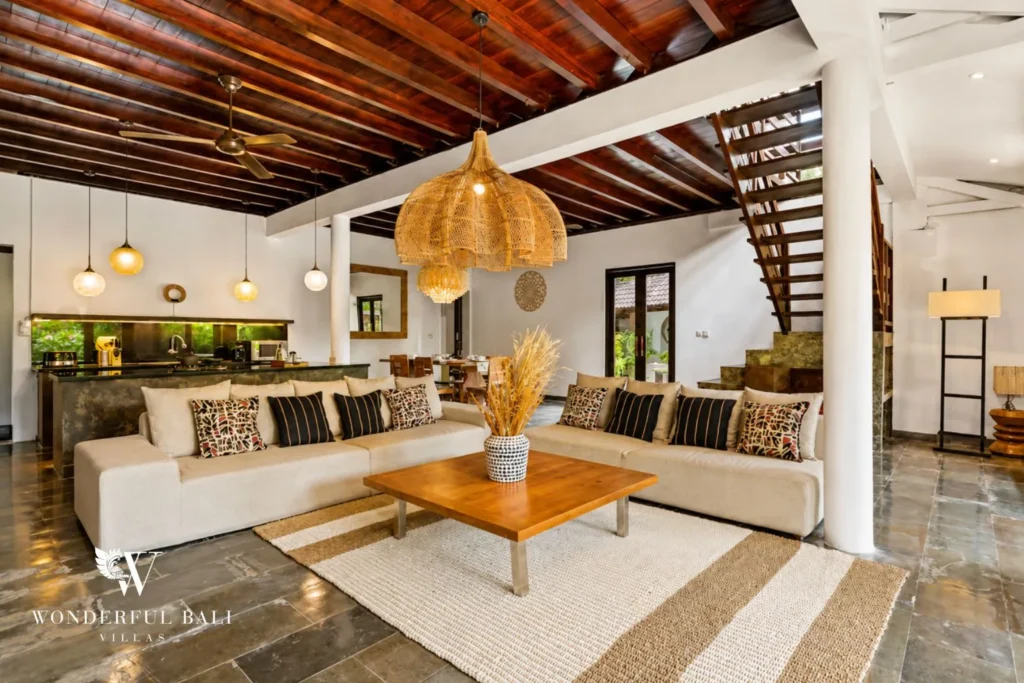 Open-plan living lounge with rattan pendant and coffee table at villa in Umalas, Bali