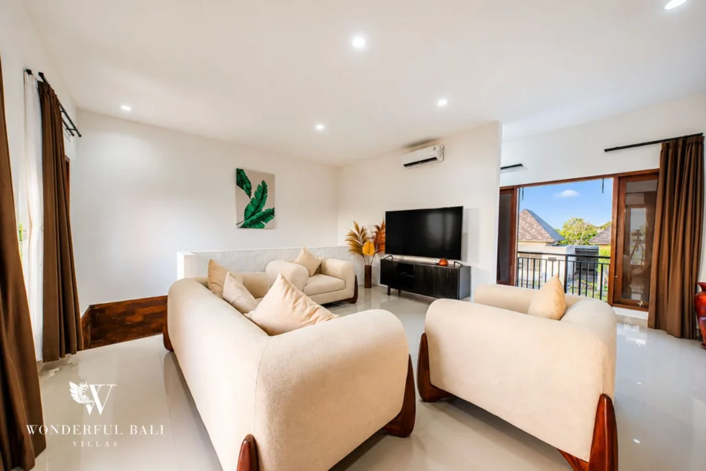 Living room with beige sofas and balcony access in Nyanyi, Bali