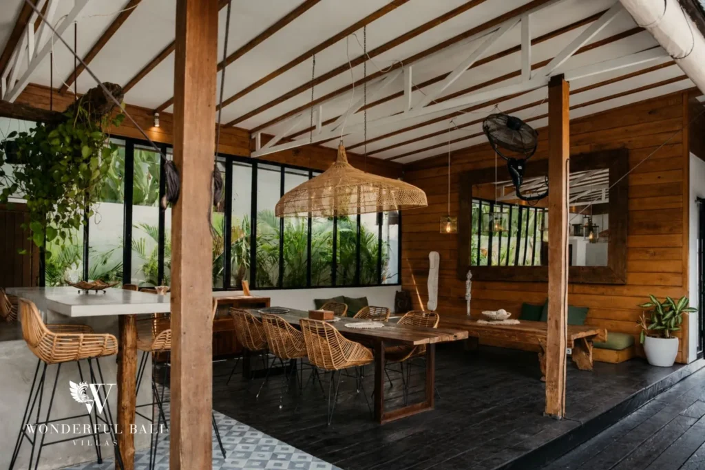 Open-plan living and dining with rustic timber finishes at villa in Canggu, Bali