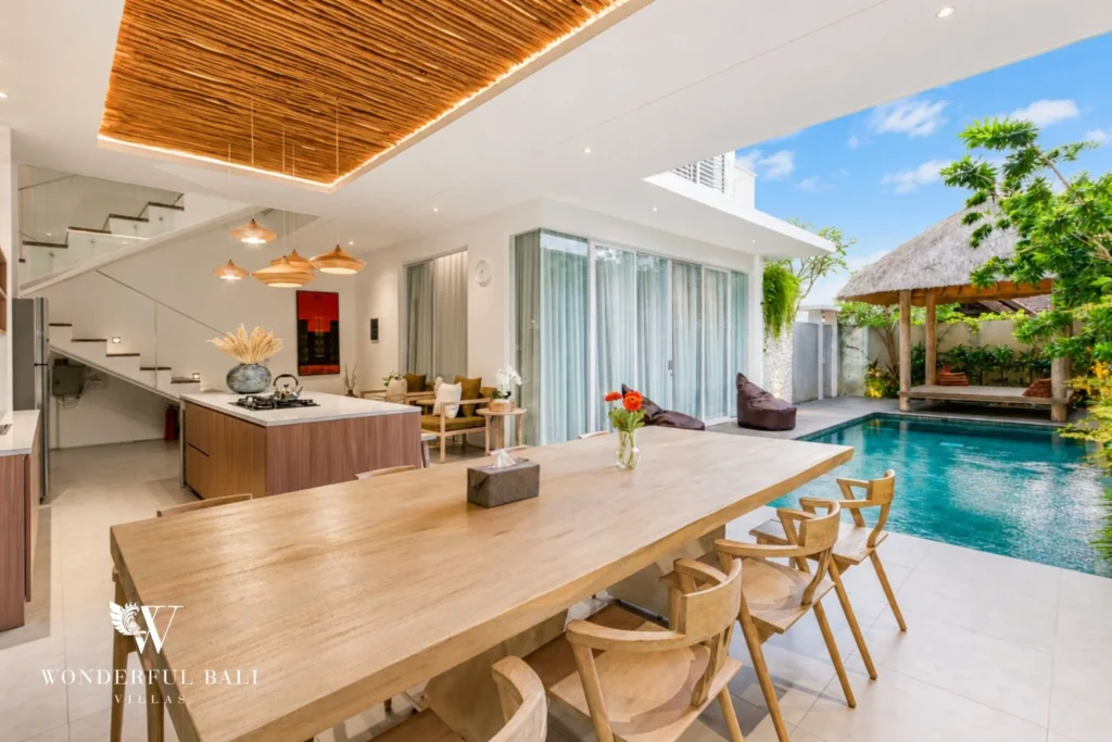Private pool with the open kitchen and dining area opening onto the deck at villa in Petitenget, Bali