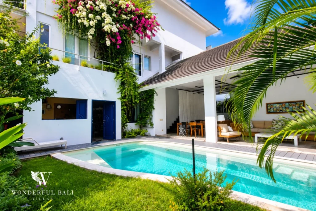 Lap pool with grass border and outdoor lounge view at villa in Umalas, Bali