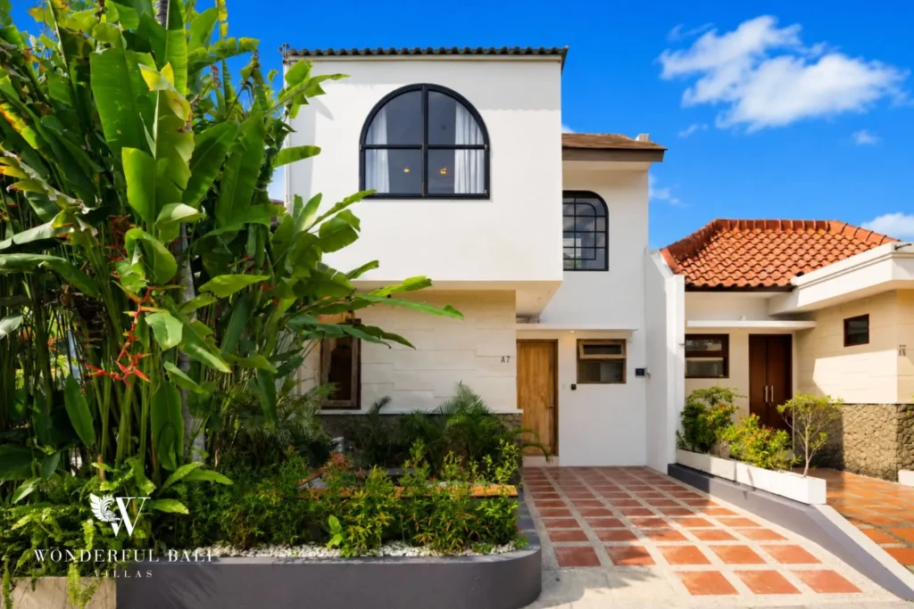 Two-storey white villa with arched windows and terracotta roof at villa in Canggu, Bali