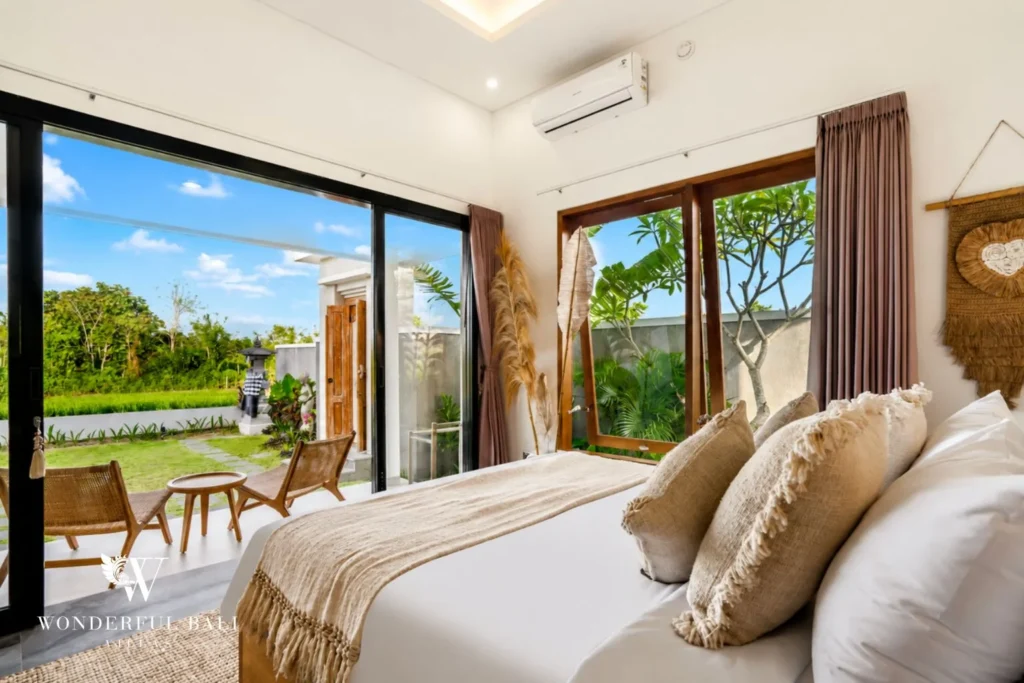 Bedroom with sliding glass doors to the garden at villa in Ubud, Bali
